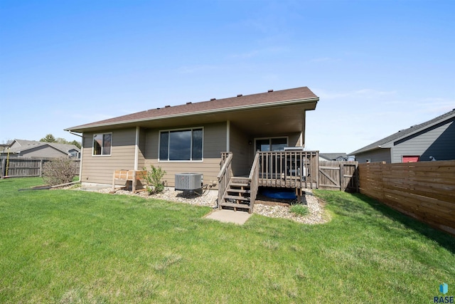 rear view of house featuring a yard, cooling unit, a wooden deck, and a fenced backyard