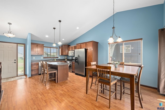 dining area featuring recessed lighting, high vaulted ceiling, a chandelier, and light wood-style floors
