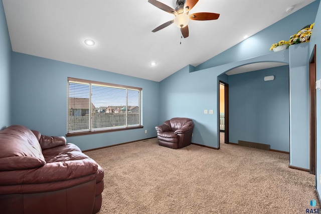 living room featuring carpet flooring, ceiling fan, baseboards, and lofted ceiling