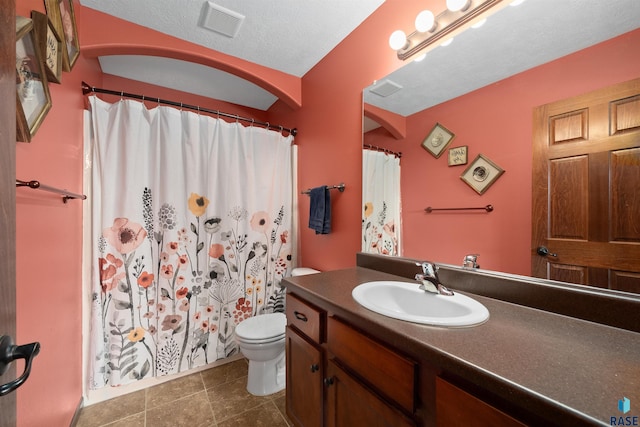 bathroom with vanity, toilet, tile patterned floors, a shower with curtain, and visible vents