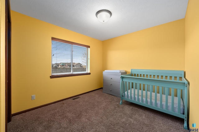 carpeted bedroom with baseboards, a crib, and visible vents
