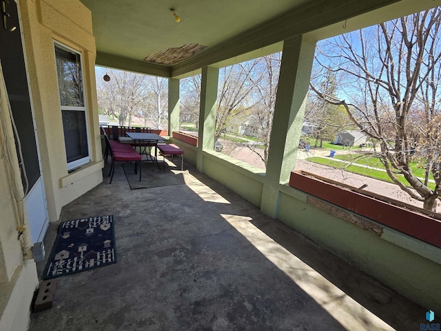 sunroom featuring outdoor dining space