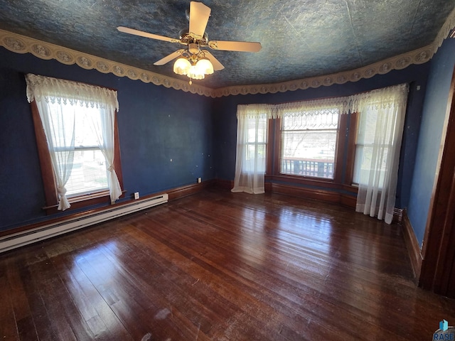 empty room with wood-type flooring, ceiling fan, baseboards, and a baseboard radiator