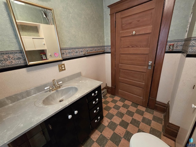 bathroom featuring tile patterned floors, vanity, and toilet