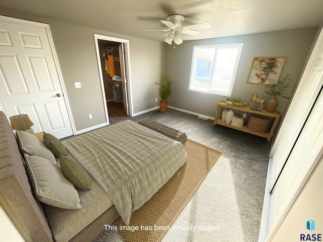 813 S Edward Cir, Sioux Falls, SD 57103 - carpeted bedroom with baseboards, a walk in closet, a closet, and ceiling fan