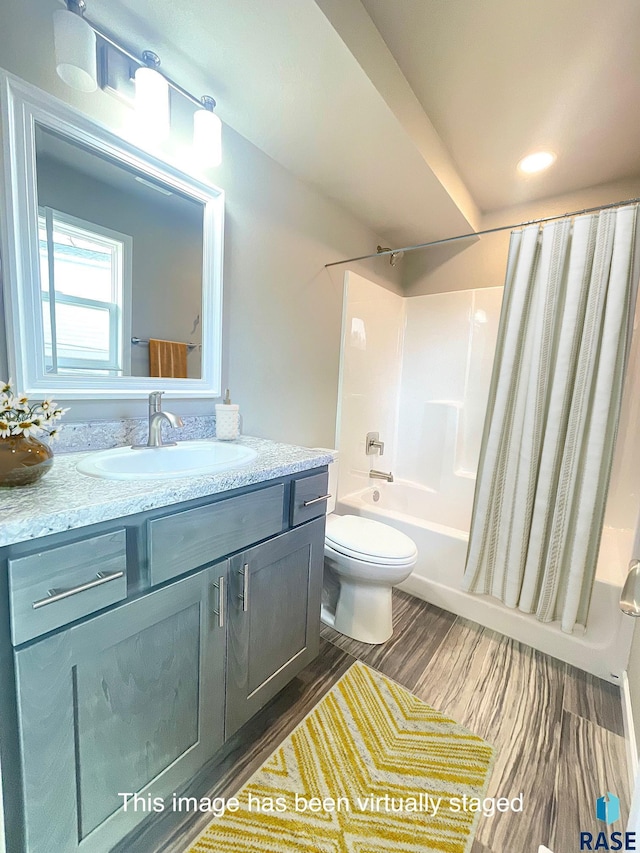 813 S Edward Cir, Sioux Falls, SD 57103 - bathroom with vanity, shower / bath combo with shower curtain, toilet, and wood finished floors