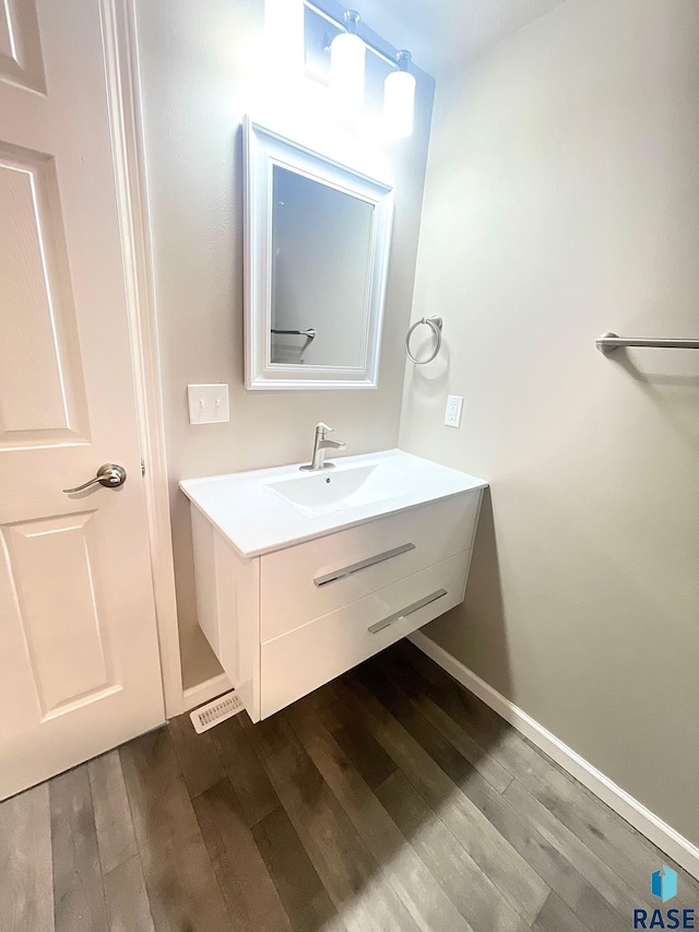 813 S Edward Cir, Sioux Falls, SD 57103 - bathroom with baseboards, wood finished floors, and vanity