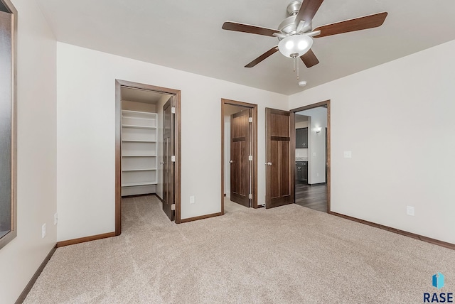 5714 S Woodlily Ave, Sioux Falls, SD 57108 - unfurnished bedroom featuring carpet, a closet, baseboards, ensuite bath, and a spacious closet
