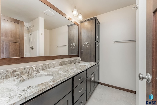 5714 S Woodlily Ave, Sioux Falls, SD 57108 - full bath featuring a sink, tile patterned flooring, double vanity, and baseboards
