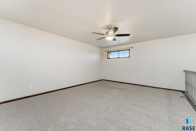 5714 S Woodlily Ave, Sioux Falls, SD 57108 - spare room featuring baseboards, light carpet, and a ceiling fan