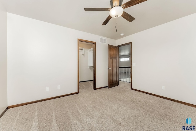 5714 S Woodlily Ave, Sioux Falls, SD 57108 - empty room featuring light colored carpet, visible vents, baseboards, and ceiling fan