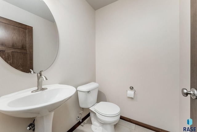 5714 S Woodlily Ave, Sioux Falls, SD 57108 - bathroom featuring tile patterned floors, toilet, baseboards, and a sink