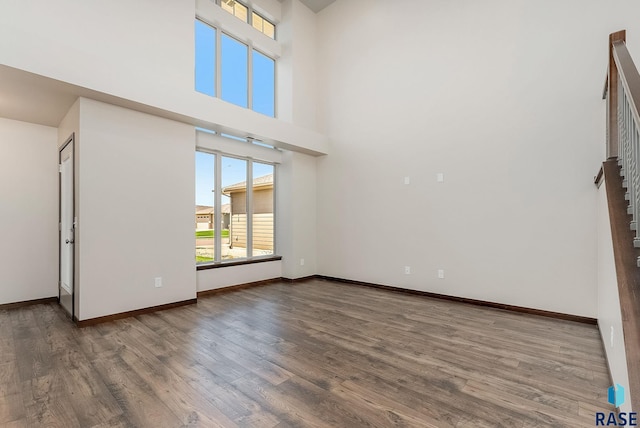 5714 S Woodlily Ave, Sioux Falls, SD 57108 - spare room featuring wood finished floors, baseboards, and a high ceiling