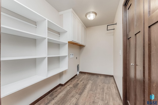 5714 S Woodlily Ave, Sioux Falls, SD 57108 - washroom featuring light wood finished floors, cabinet space, washer hookup, hookup for an electric dryer, and baseboards