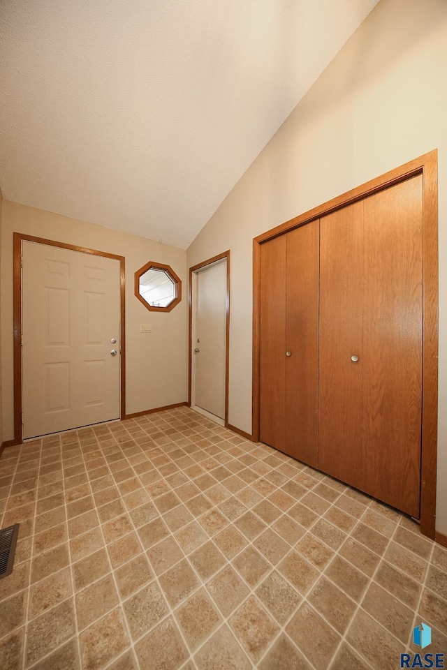 entrance foyer featuring lofted ceiling