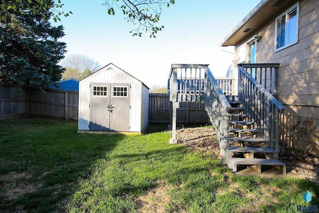 view of yard featuring stairs, a shed, and an outdoor structure