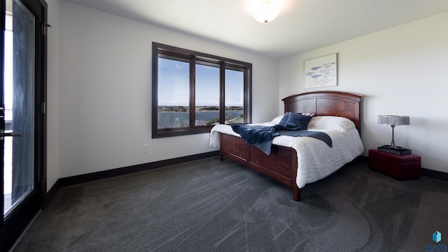 bedroom with baseboards and dark colored carpet