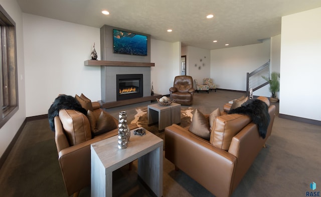living area with baseboards, a tile fireplace, recessed lighting, and carpet