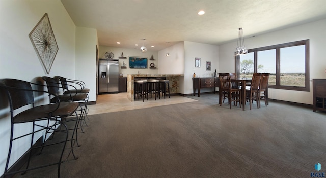 dining area featuring baseboards, a chandelier, recessed lighting, and light colored carpet