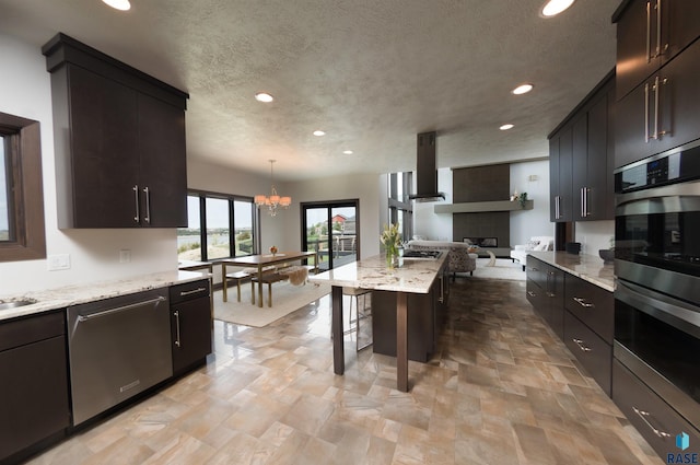 kitchen featuring open floor plan, stainless steel appliances, exhaust hood, and recessed lighting
