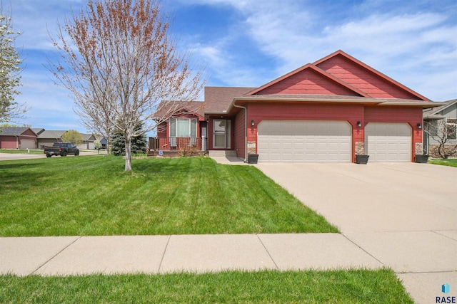 view of front facade with concrete driveway, a front yard, and a garage