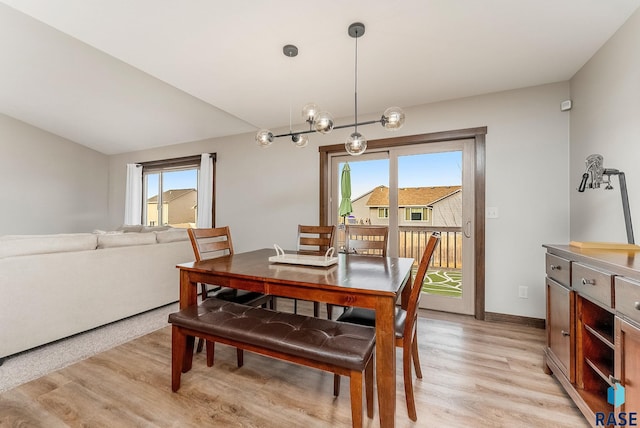 dining space featuring light wood-type flooring and baseboards