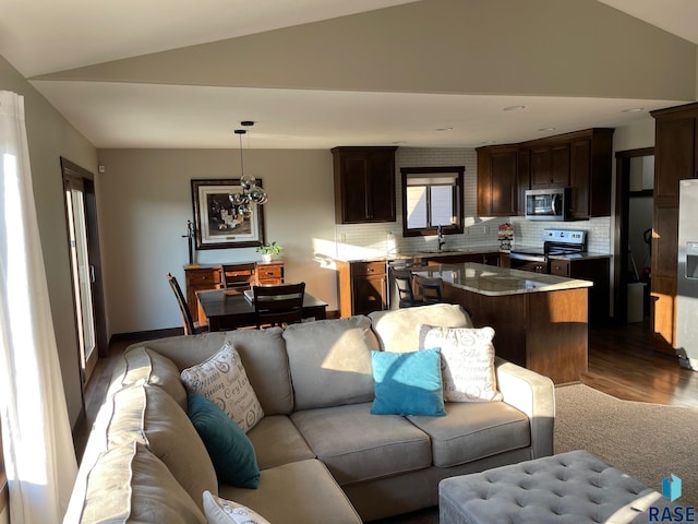 living room with lofted ceiling and wood finished floors