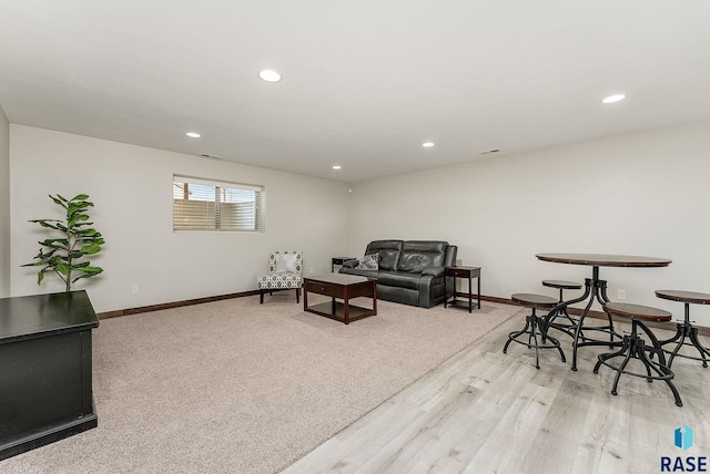 living room with baseboards, light wood-style floors, and recessed lighting