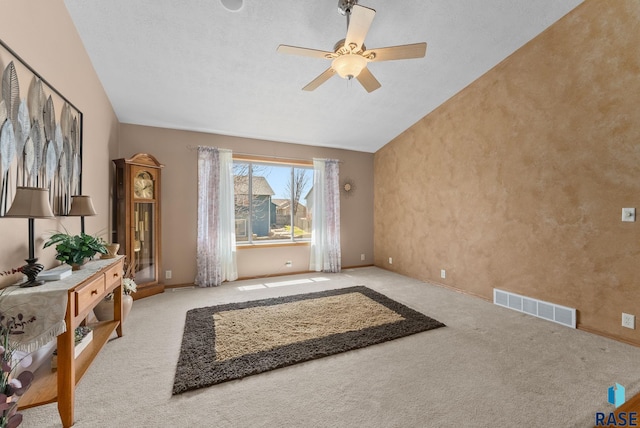 carpeted living area featuring lofted ceiling, baseboards, a ceiling fan, and visible vents