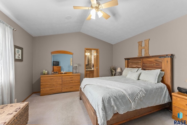 bedroom with light carpet, ensuite bath, ceiling fan, and vaulted ceiling