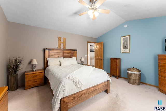 bedroom featuring vaulted ceiling, light carpet, baseboards, and ceiling fan