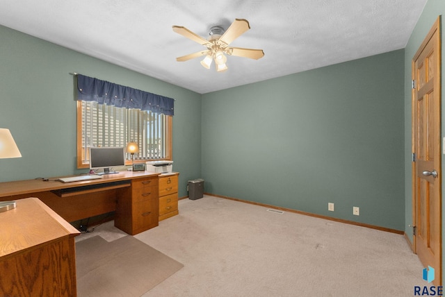 home office with light colored carpet, baseboards, and a ceiling fan
