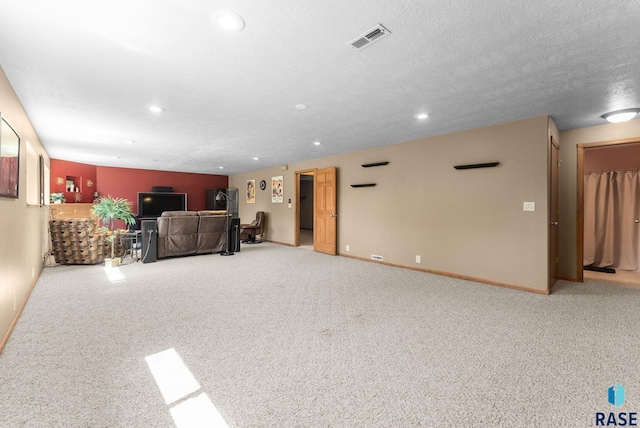 unfurnished living room featuring carpet flooring, baseboards, visible vents, and recessed lighting