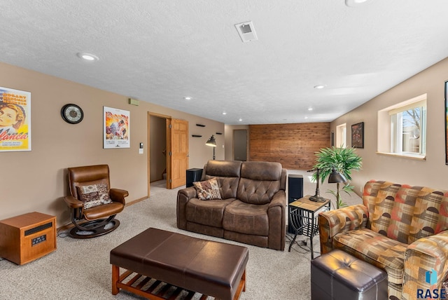 living area with carpet, visible vents, and recessed lighting