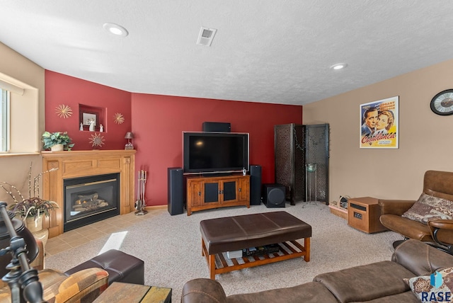 carpeted living room with a fireplace with flush hearth, visible vents, and recessed lighting