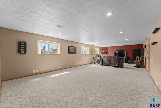 unfurnished living room with plenty of natural light, visible vents, carpet floors, and recessed lighting