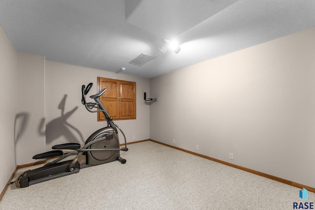exercise area with baseboards, carpet flooring, and visible vents