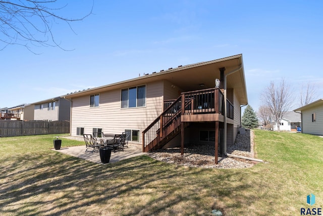 back of property with a patio area, stairway, fence, and a lawn