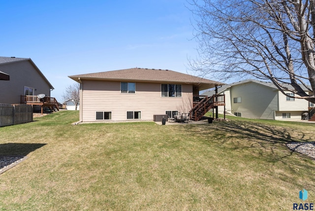 back of property featuring a lawn, stairway, and a wooden deck