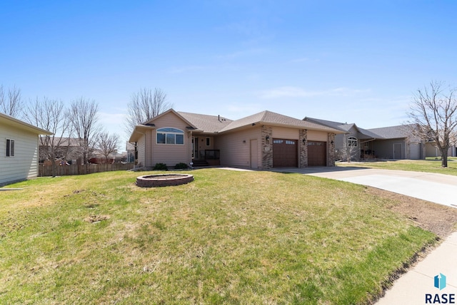 ranch-style home with a front yard, fence, an attached garage, and driveway