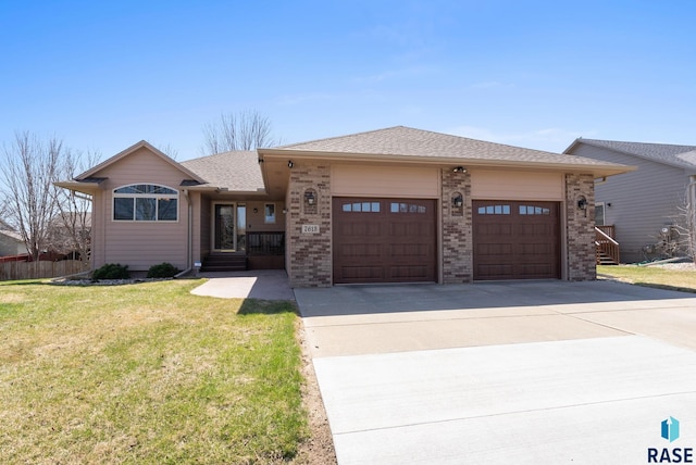 view of front of property with roof with shingles, brick siding, concrete driveway, a garage, and a front yard
