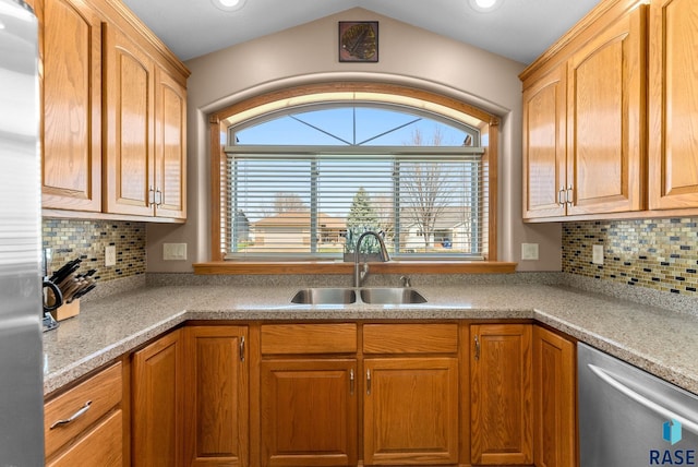 kitchen with light countertops, appliances with stainless steel finishes, decorative backsplash, and a sink