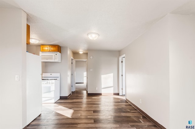 interior space featuring baseboards, dark wood finished floors, and a textured ceiling