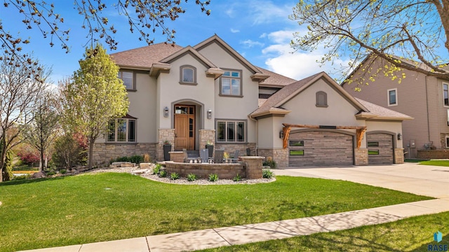 5604 S Jersey Tess Dr, Sioux Falls, SD 57108 - view of front of house with an attached garage, stone siding, driveway, stucco siding, and a front yard