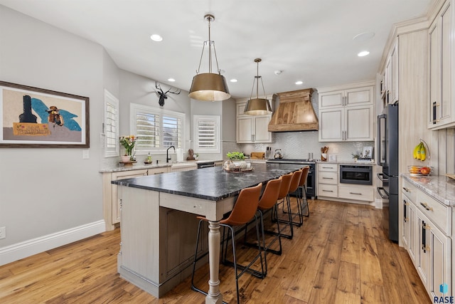 5604 S Jersey Tess Dr, Sioux Falls, SD 57108 - kitchen with high quality fridge, a center island, stainless steel electric range, a sink, and premium range hood