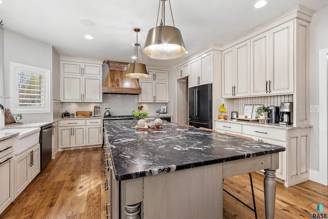 5604 S Jersey Tess Dr, Sioux Falls, SD 57108 - kitchen with premium range hood, freestanding refrigerator, stainless steel dishwasher, a kitchen island, and light wood-style floors