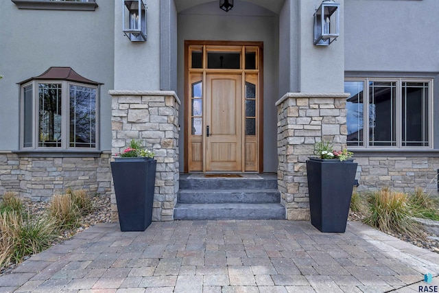 5604 S Jersey Tess Dr, Sioux Falls, SD 57108 - view of exterior entry featuring stucco siding and stone siding
