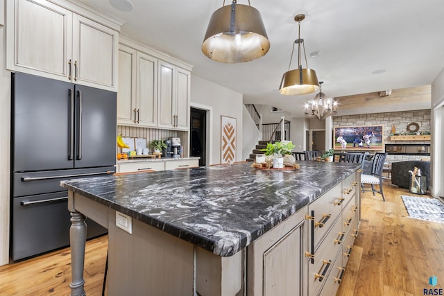 5604 S Jersey Tess Dr, Sioux Falls, SD 57108 - kitchen featuring light wood-type flooring, pendant lighting, a chandelier, decorative backsplash, and high end refrigerator