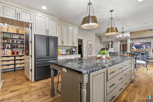 5604 S Jersey Tess Dr, Sioux Falls, SD 57108 - kitchen featuring light wood-type flooring, high end fridge, pendant lighting, a kitchen island, and a notable chandelier