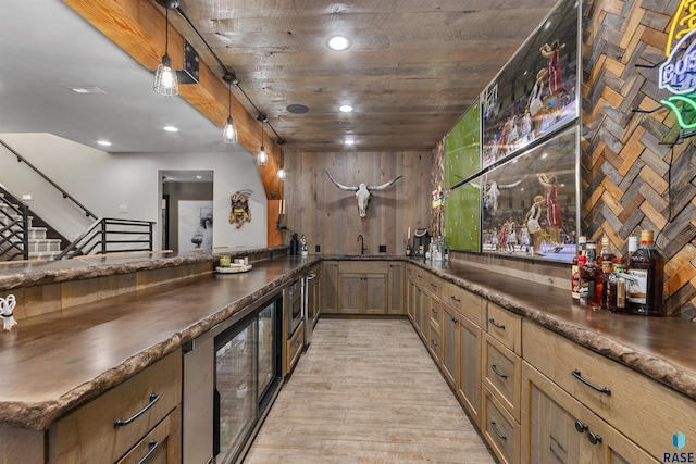 5604 S Jersey Tess Dr, Sioux Falls, SD 57108 - bar featuring pendant lighting, light wood-style flooring, beverage cooler, a sink, and indoor bar